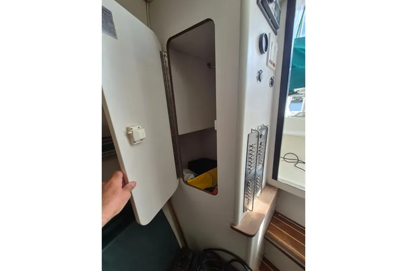 Slide: The Image of Interior view of a 1996 Pursuit 3000 Offshore boat, showing an open storage compartment. - 37