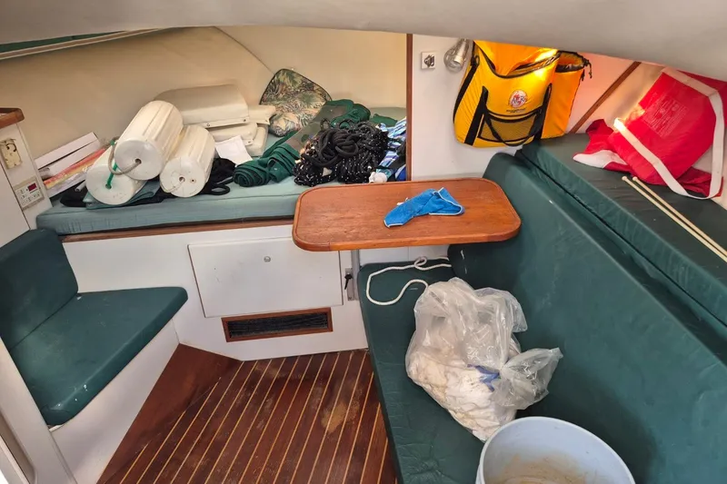 Slide: The Image of Interior of a 1996 Pursuit 3000 Offshore boat with seating and storage items. - 51