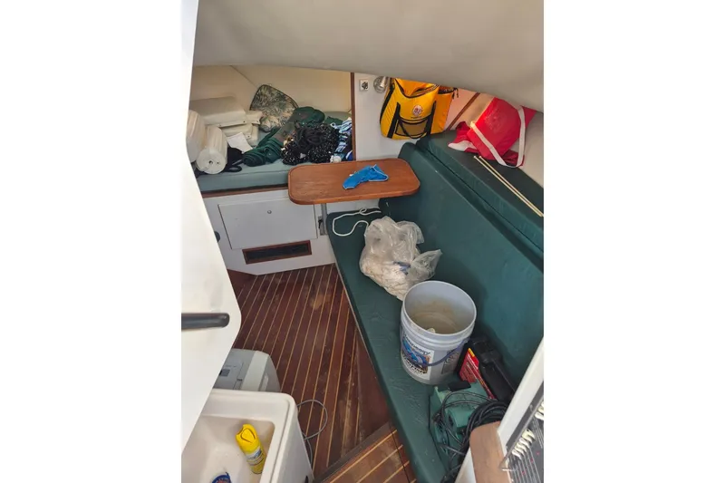 Slide: The Image of Interior of a 1996 Pursuit 3000 Offshore boat with seating and storage items. - 50