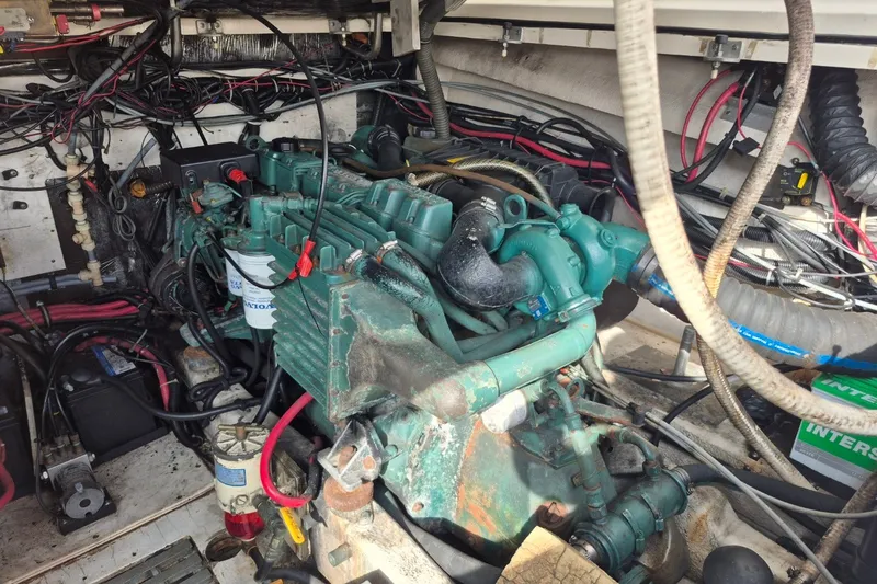 Slide: The Image of Engine compartment of a 1996 Pursuit 3000 Offshore boat, showcasing wiring and components. - 26