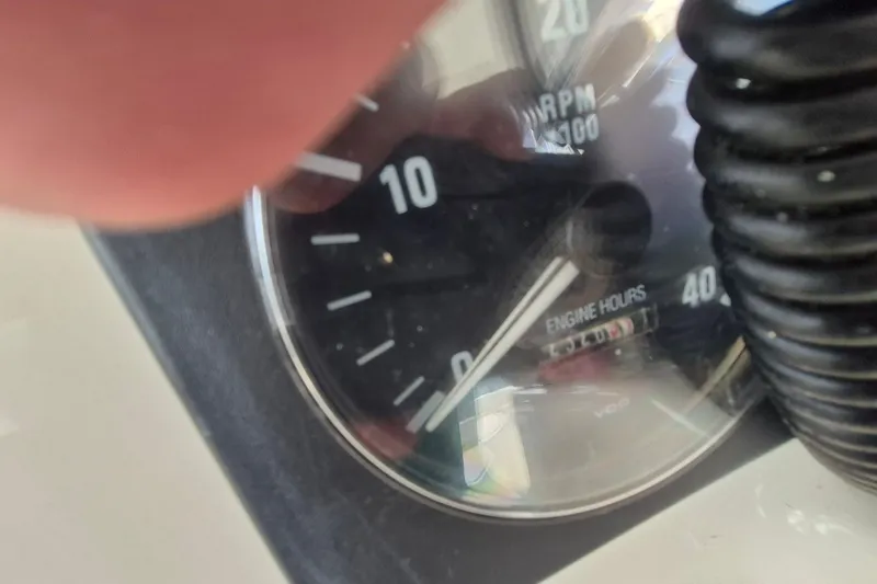 Slide: The Image of Close-up of a 1996 Pursuit 3000 Offshore tachometer showing RPM and engine hours. - 34