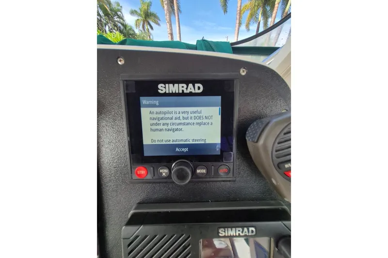 Slide: The Image of Simrad autopilot warning on 1996 Pursuit 3000 Offshore boat dashboard. - 35