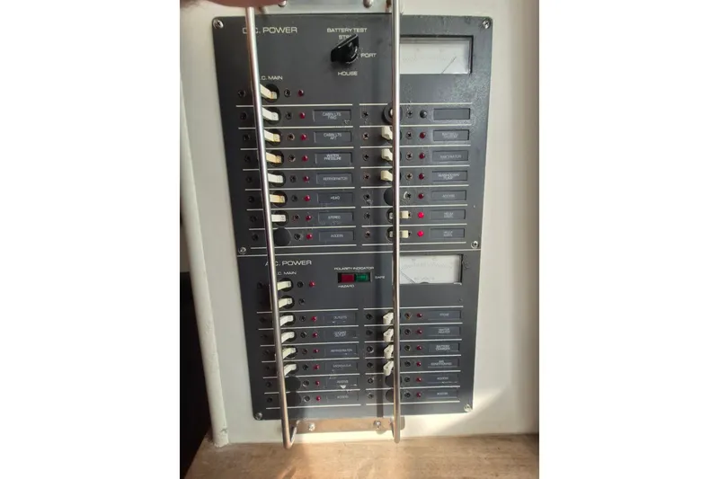 Slide: The Image of Electrical control panel on a 1996 Pursuit 3000 Offshore boat, featuring various switches and indicators. - 36