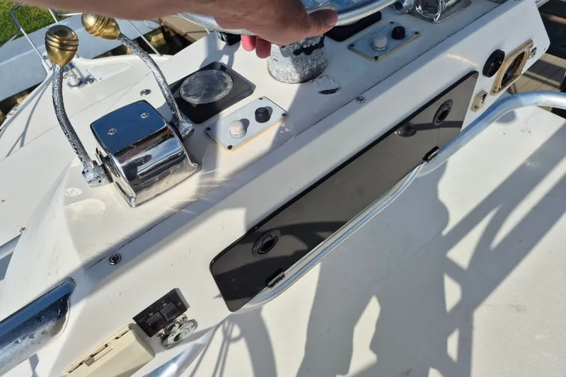 Slide: The Image of Control panel of a 1996 Pursuit 3000 Offshore boat with throttle levers and switches. - 58