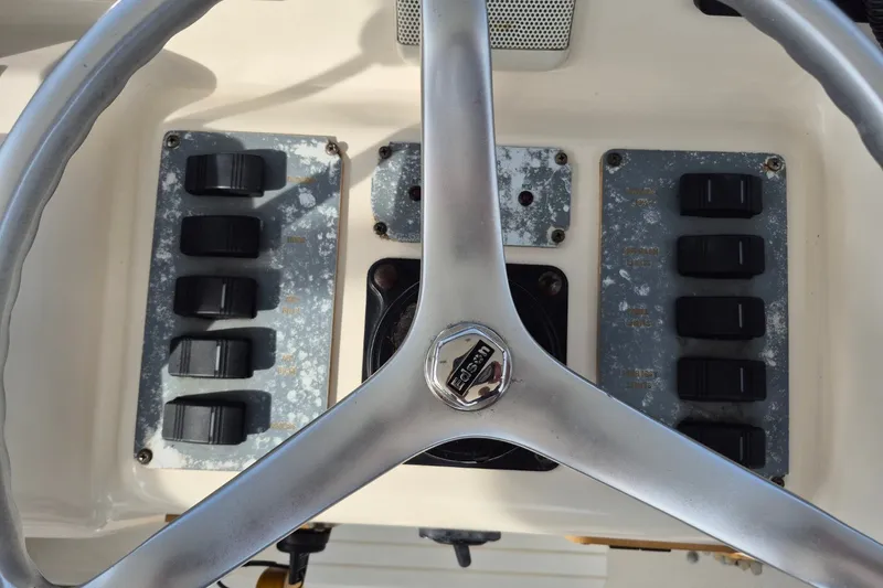 Slide: The Image of Steering wheel and control panel of 1996 Pursuit 3000 Offshore boat. - 22