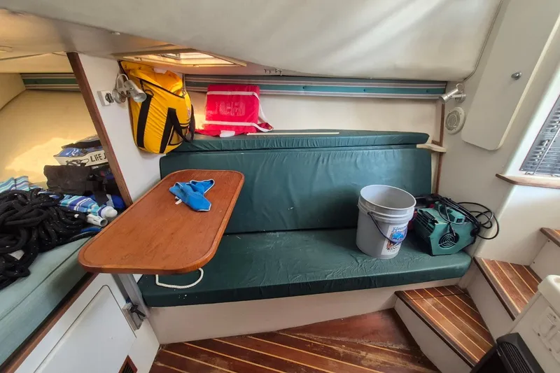 Slide: The Image of Interior of a 1996 Pursuit 3000 Offshore boat with seating, table, and equipment. - 46