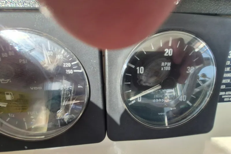 Slide: The Image of Close-up of Pursuit 3000 Offshore 1996 boat gauges showing RPM and PSI readings. - 33
