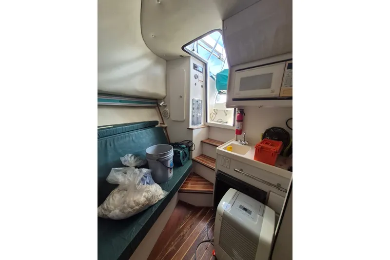 Slide: The Image of Interior of a 1996 Pursuit 3000 Offshore boat with kitchenette and seating area. - 45