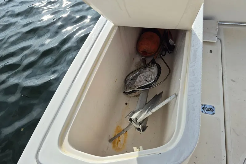 Slide: The Image of Storage compartment on a 1996 Pursuit 3000 Offshore boat with anchor and buoy. - 16