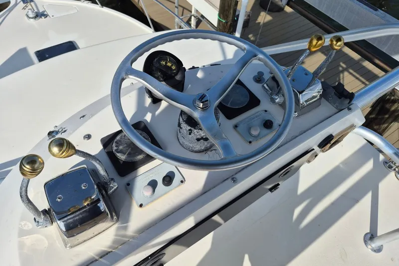 Slide: The Image of Helm of a 1996 Pursuit 3000 Offshore boat with steering wheel and controls. - 57