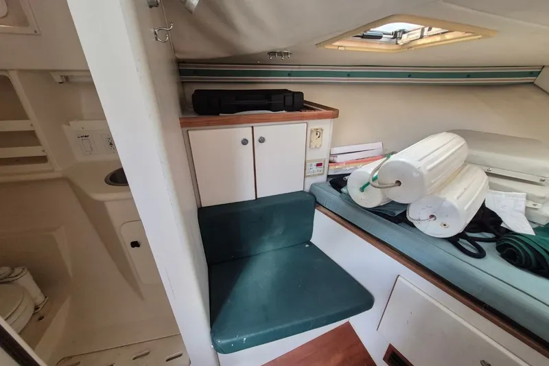 Slide: The Image of Interior of a 1996 Pursuit 3000 Offshore boat with seating and storage. - 44
