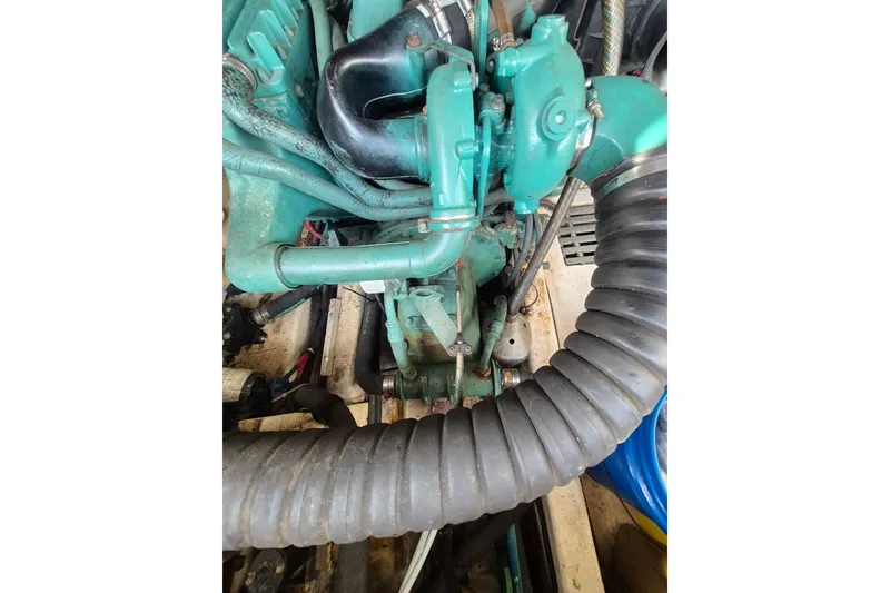 Slide: The Image of Engine compartment of a 1996 Pursuit 3000 Offshore boat, showcasing mechanical components. - 29
