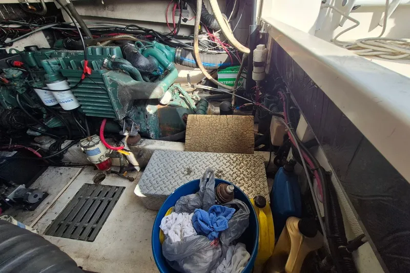 Slide: The Image of Engine room of a 1996 Pursuit 3000 Offshore boat with visible equipment and supplies. - 31