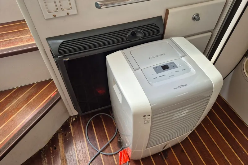 Slide: The Image of Frigidaire dehumidifier on 1996 Pursuit 3000 Offshore boat with wooden flooring. - 47