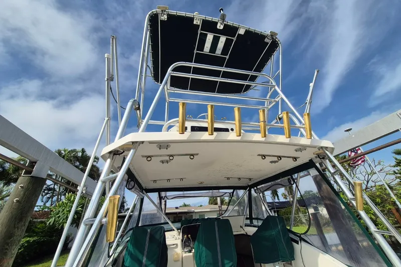 Slide: The Image of 1996 Pursuit 3000 Offshore boat with tower, viewed from below against a blue sky. - 28
