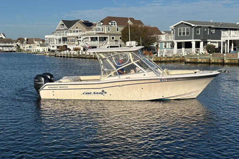 Slide: The Image of 2008 Grady-White Freedom 275 boat on water near waterfront homes. - 3