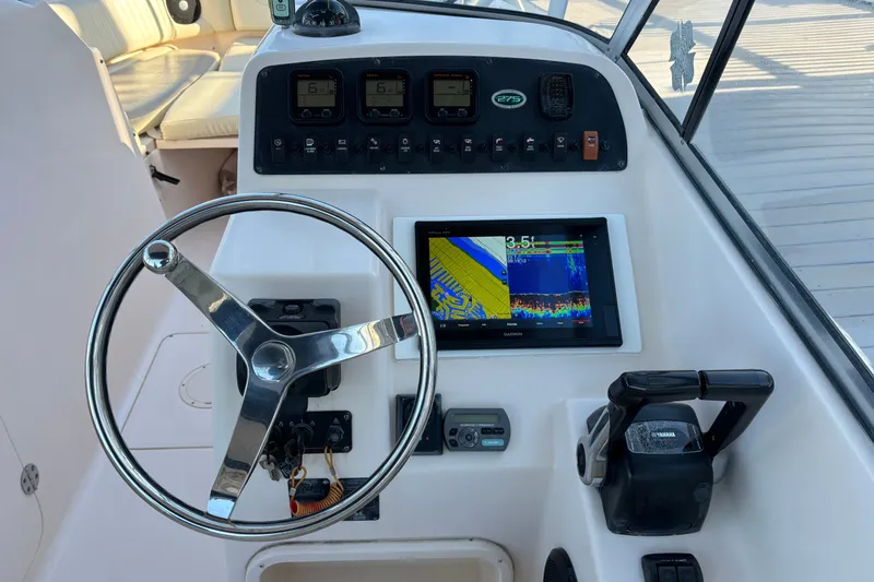 Slide: The Image of Grady-White Freedom 275 boat dashboard with steering wheel and Garmin display, 2008 model. - 9