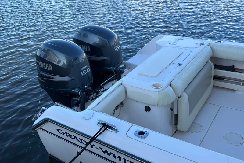 Slide: The Image of Grady-White Freedom 275 boat with twin Yamaha 150 engines on calm water. - 28