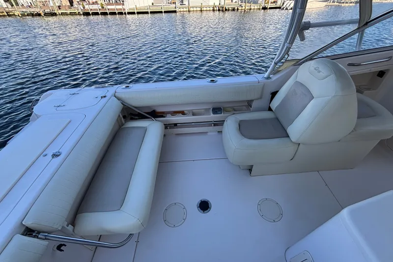 Slide: The Image of 2008 Grady-White Freedom 275 boat interior with white seating by the water. - 22