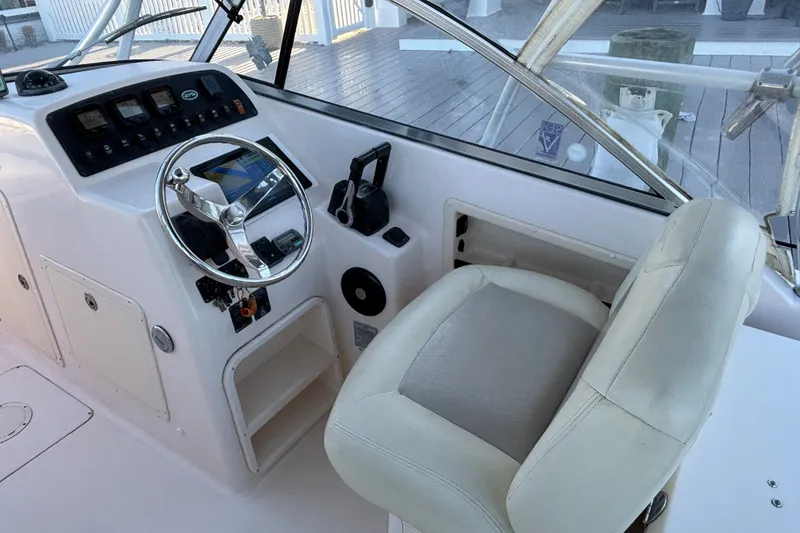 Slide: The Image of Helm of 2008 Grady-White Freedom 275 boat with steering wheel and controls. - 14