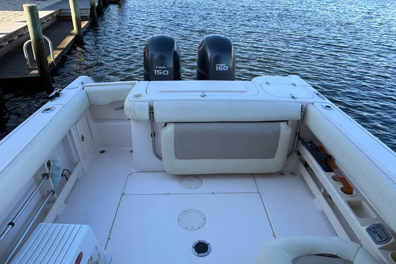 Slide: The Image of 2008 Grady-White Freedom 275 boat with twin Yamaha 150 engines docked by the water. - 25