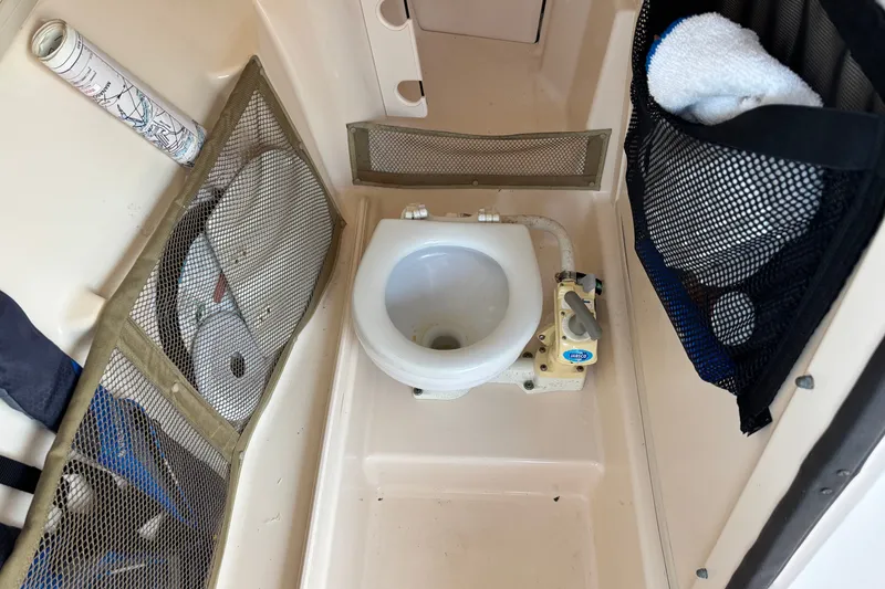 Slide: The Image of Boat bathroom interior on a 2008 Grady-White Freedom 275, featuring a compact toilet. - 20