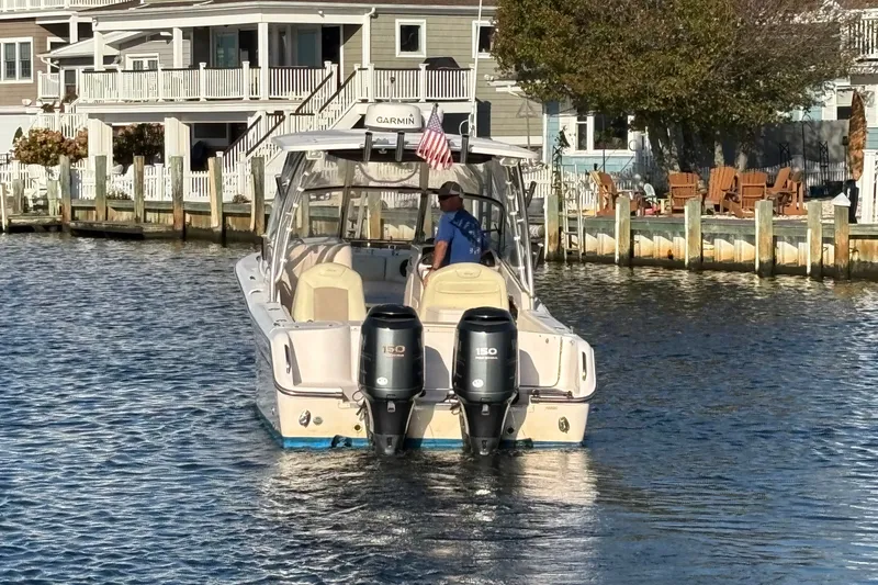 Slide: The Image of Grady-White Freedom 275 boat from 2008 on water near waterfront homes. - 5