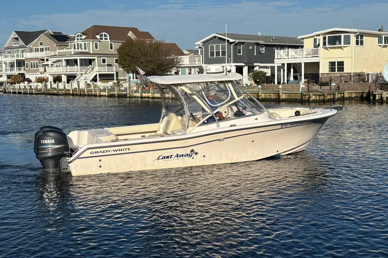 Slide: The Image of 2008 Grady-White Freedom 275 boat on water near waterfront homes. - 4
