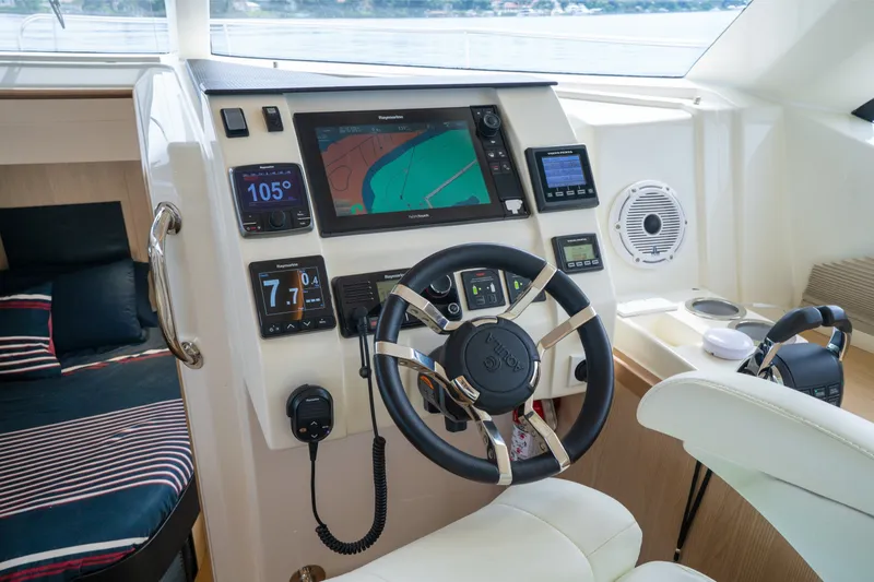 Slide: The Image of Cockpit of 2018 Aquila 44 Yacht with modern navigation equipment and steering wheel. - 25