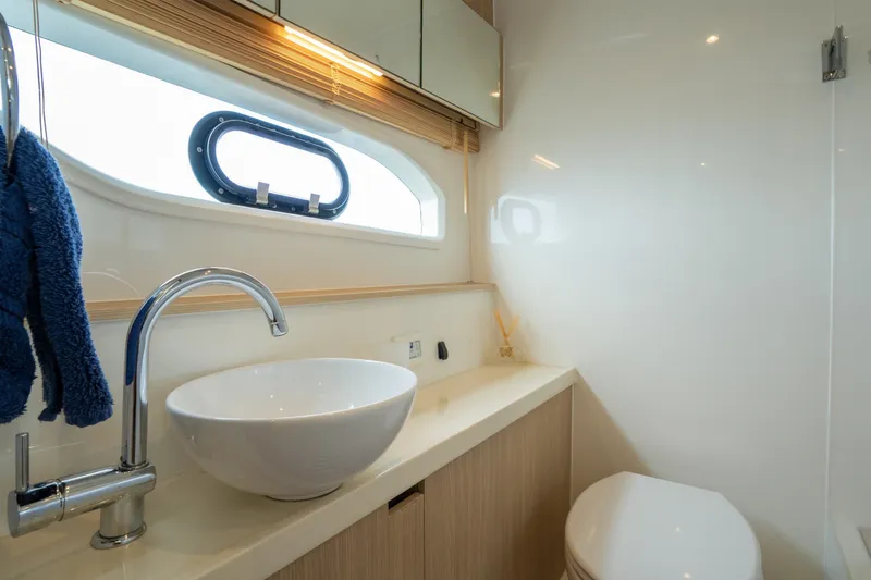 Slide: The Image of Luxurious bathroom interior of 2018 Aquila 44 Yacht with modern sink and porthole window. - 33