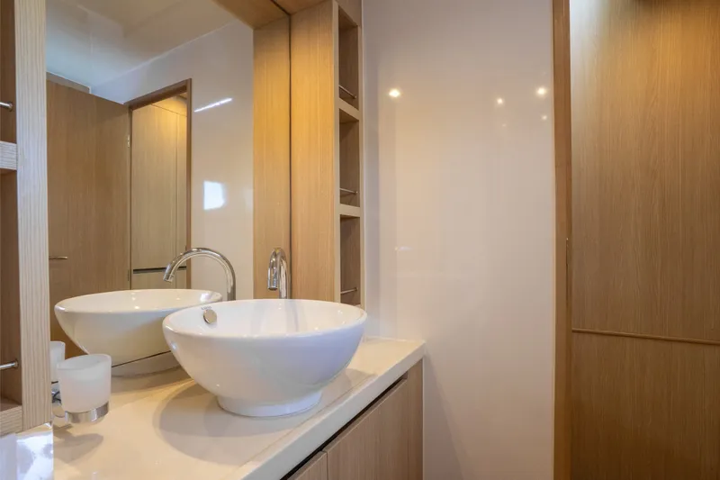 Slide: The Image of Modern bathroom interior on 2018 Aquila 44 Yacht, featuring sleek sink and wooden cabinetry. - 29