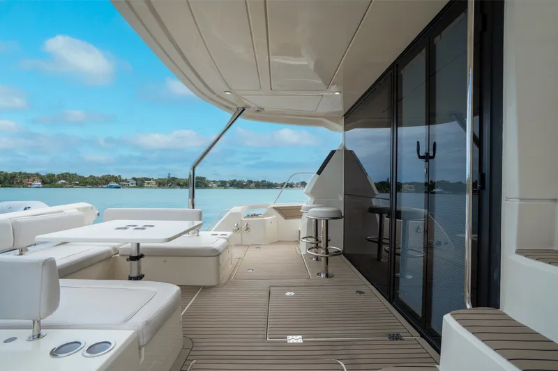 Slide: The Image of Luxurious 2018 Aquila 44 Yacht deck with seating, table, and scenic water view. - 17