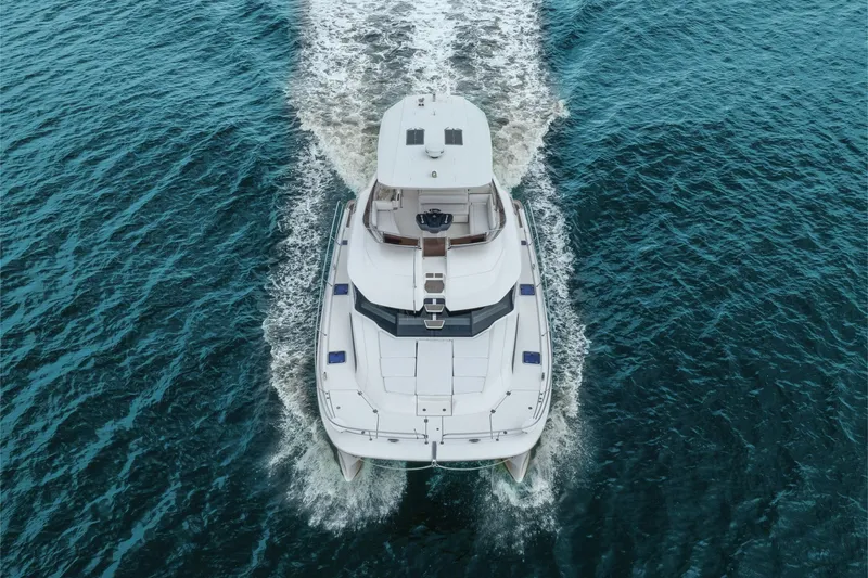 Slide: The Image of Aquila 44 Yacht 2018 cruising on open water, aerial view. - 15