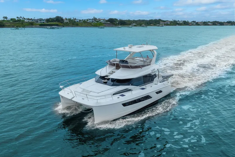 Slide: The Image of Aquila 44 Yacht cruising on blue waters, 2018 model, showcasing sleek design and luxury. - 13