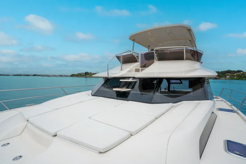 Slide: The Image of 2018 Aquila 44 Yacht on serene water, showcasing sleek design and spacious deck. - 35