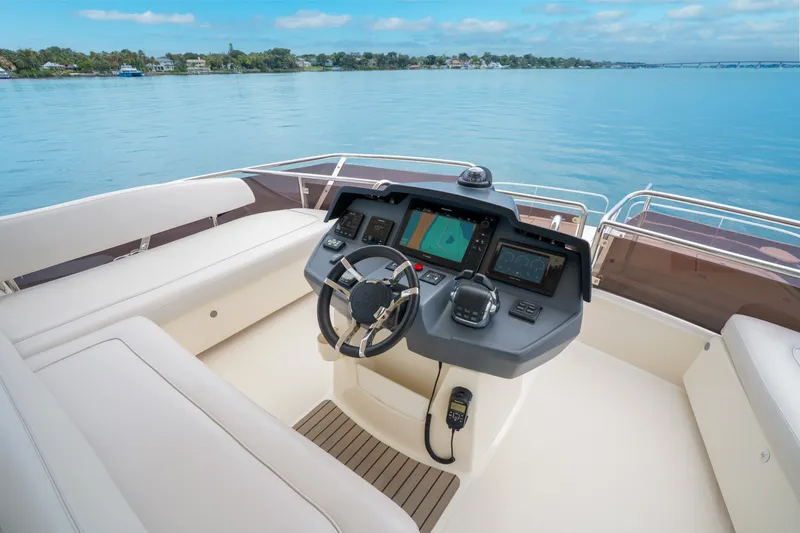 Slide: The Image of Cockpit of 2018 Aquila 44 Yacht with modern navigation controls and serene water view. - 37