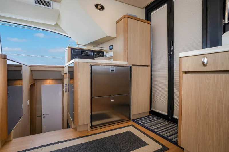 Slide: The Image of Interior of 2018 Aquila 44 Yacht featuring modern kitchen cabinetry and stainless steel appliances. - 23