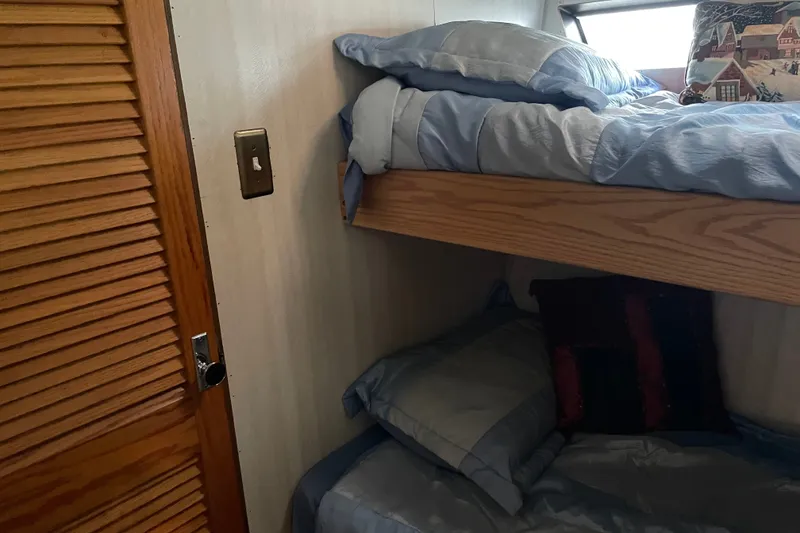 Slide: The Image of Bunk beds in a 1996 WEIST 62 Convertible yacht cabin with cozy bedding. - 17
