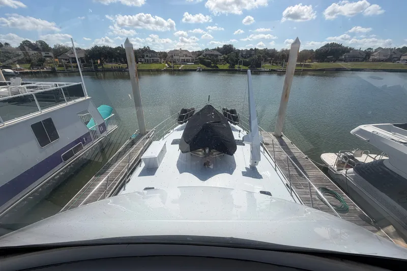 Slide: The Image of 1996 WEIST 62 Convertible yacht docked at a marina under a sunny sky. - 47