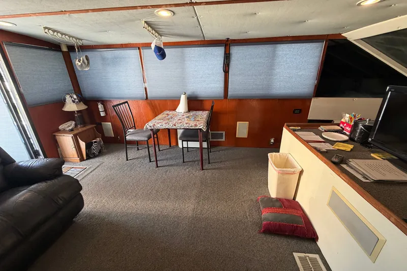 Slide: The Image of Interior of a 1996 WEIST 62 Convertible yacht with dining area and seating. - 32
