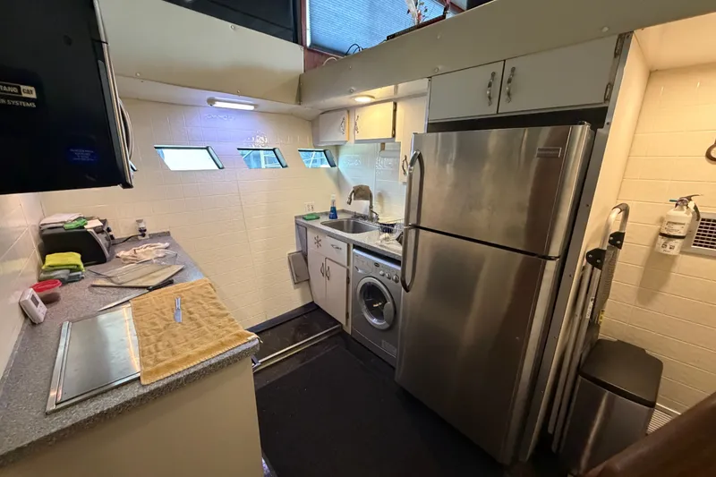 Slide: The Image of Kitchen area in a 1996 WEIST 62 Convertible yacht with modern appliances and compact design. - 27