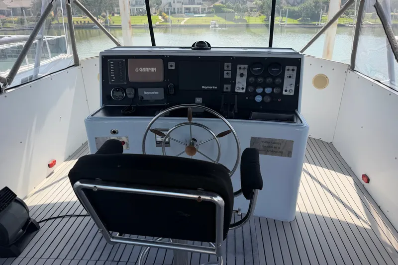 Slide: The Image of Cockpit of a 1996 WEIST 62 Convertible yacht with steering wheel and navigation equipment. - 41