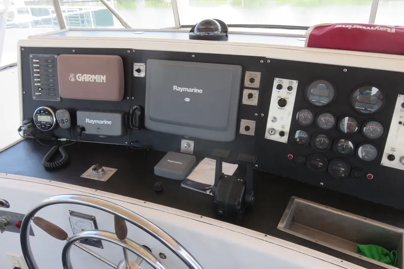 Slide: The Image of Control panel of a 1996 WEIST 62 Convertible boat with Garmin and Raymarine equipment. - 51