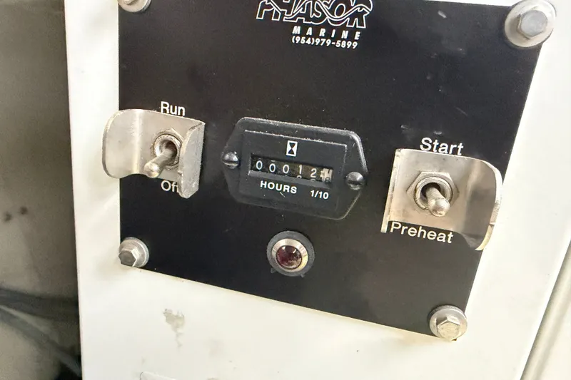 Slide: The Image of Control panel of a 1996 WEIST 62 Convertible boat with hour meter and switches. - 34