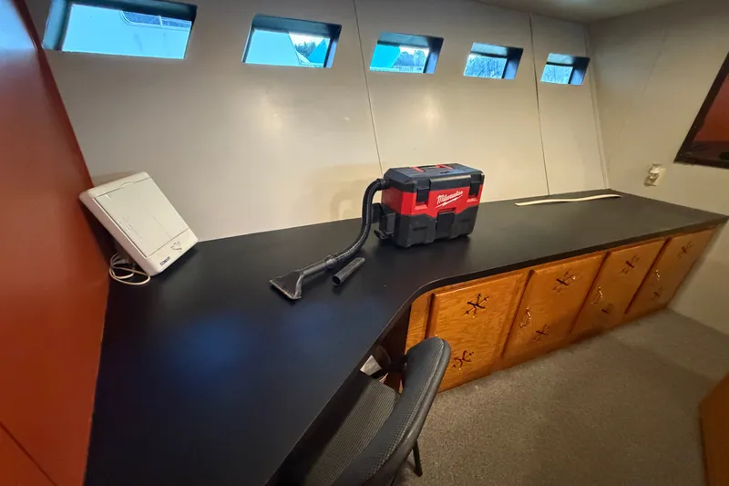 Slide: The Image of Interior of a 1996 WEIST 62 Convertible with desk, chair, and storage cabinets. - 22