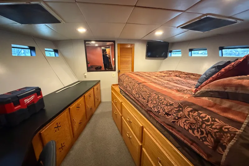 Slide: The Image of Interior of 1996 WEIST 62 Convertible yacht with bed, storage, and small windows. - 21