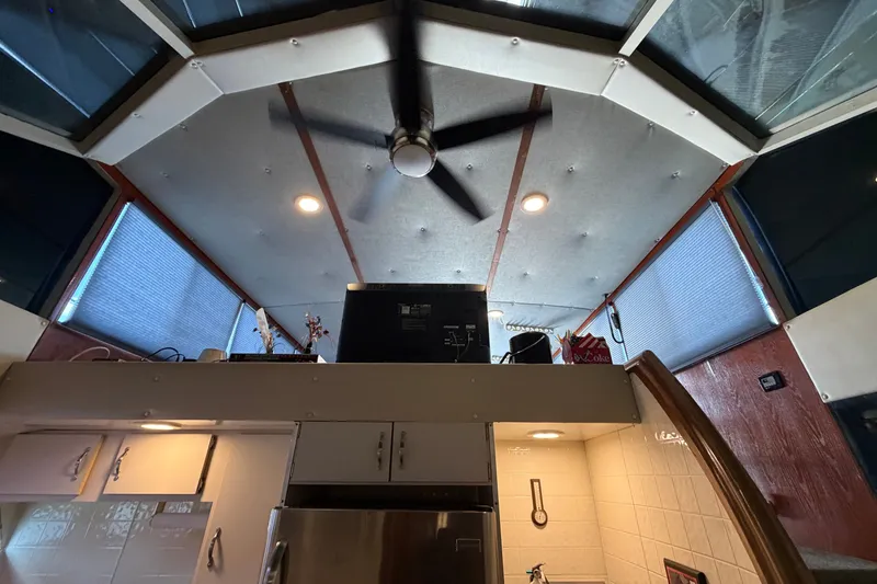 Slide: The Image of Interior view of a 1996 WEIST 62 Convertible yacht with ceiling fan and modern kitchen. - 28