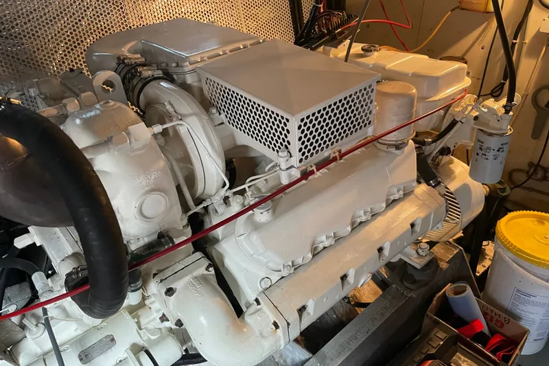Slide: The Image of Engine room of a 1996 WEIST 62 Convertible boat, showcasing a well-maintained engine. - 37