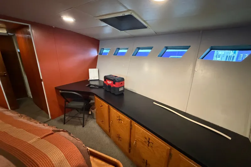 Slide: The Image of Interior of 1996 WEIST 62 Convertible yacht with desk, chair, and storage cabinets. - 26