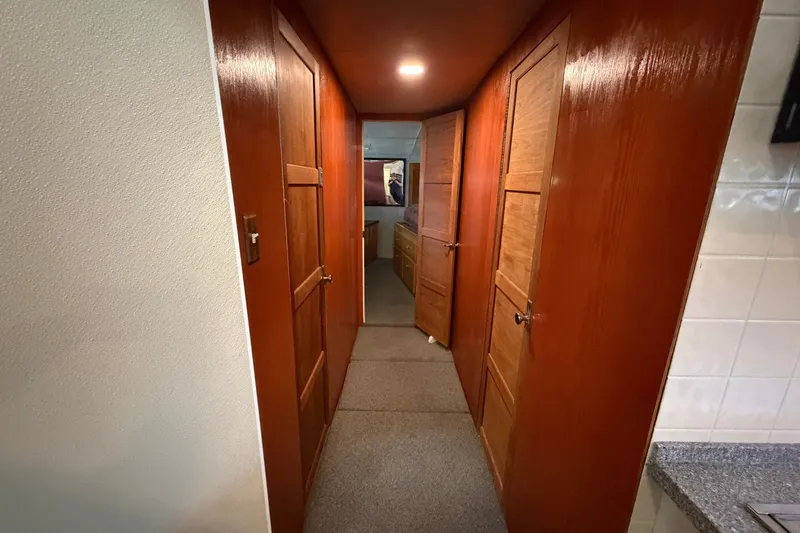 Slide: The Image of Narrow hallway with wooden doors inside a 1996 WEIST 62 Convertible yacht. - 16